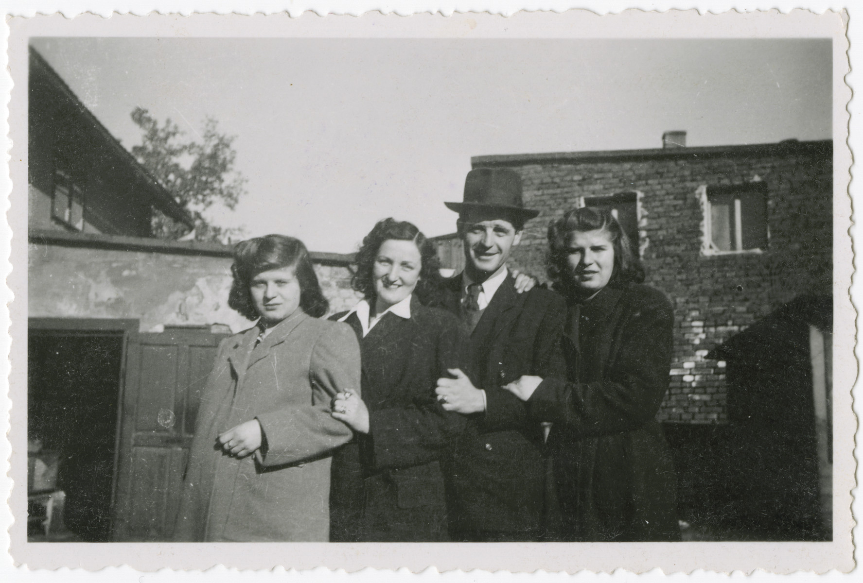 Four cousins pose togther in Kusnice prior to the German invasion.

From left to right are Helena, Esti, Bernard and Ruth.  Helena and Ruth were the sisters of Eva Weinberger.  Bernard was their cousin, and Esti was Bernard's future wife.  All four survived the Holocaust.  Bernard and Esti later immigrated to Bolivia.