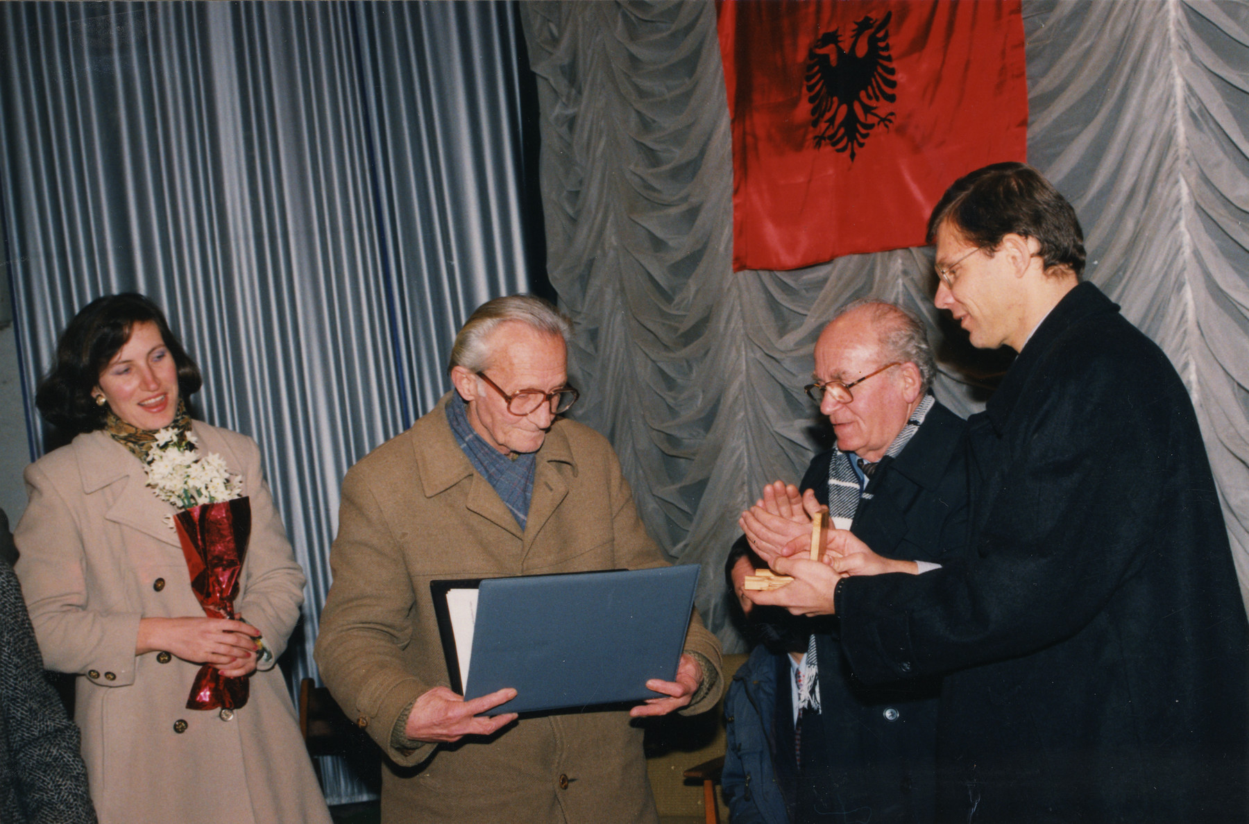 Edip Pilku accepts the Righteous Among the Nations award on behalf of his parents, rescuers, Njazi and Lisa Lotte Pilku.

Also pictured is another Albanian rescuer, Refik Veseli (second from the right) and the Israeli Ambassador, Tibor Schlosser (far right).  The daughter of Edip Pilku is standing on the far left.