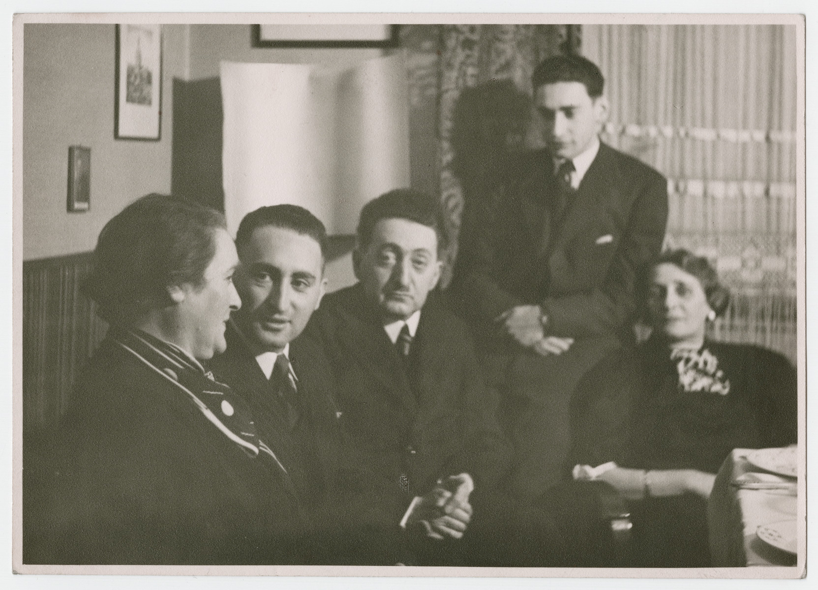 The Sonnemann family gathers in their living room.

Pictured are Bertha, Eric, Kurt, Max Sonnemann, and Frieda Hermann Berger.