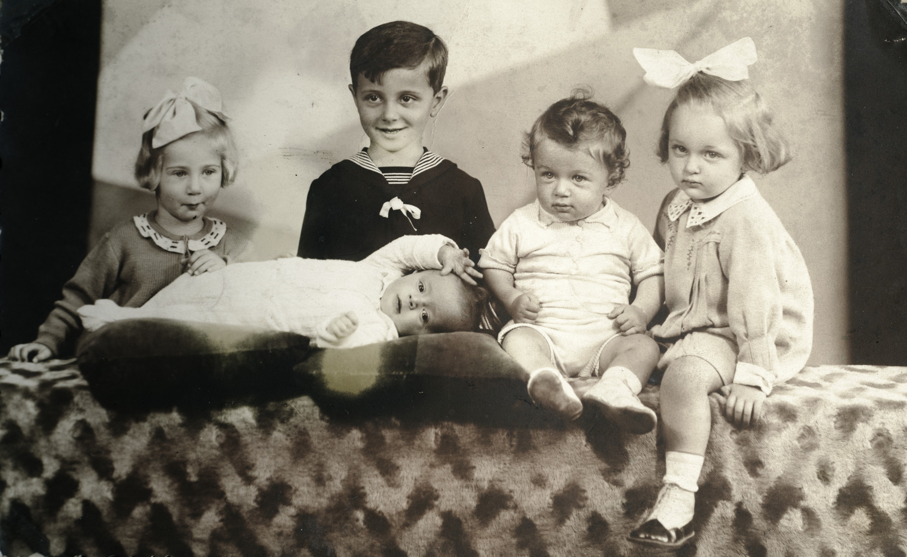 Studio portrait of five Hungarian Jewish cousins.

Judith Schonfeld is pictured on the far left.  In the center are Toni Itzkovits and his brothers (all perished).  Marika is on the far right.