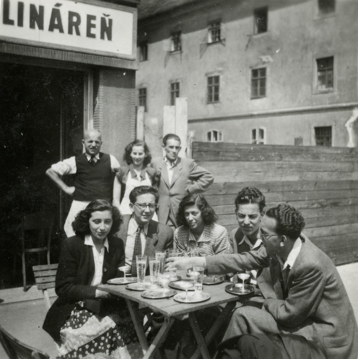 A group of friends from the Zionist youth group Gordonia stop at a cafe in Bratislava, on their way to Israel.

Pictured seated on the right are Zvi and Itzhak Braf.