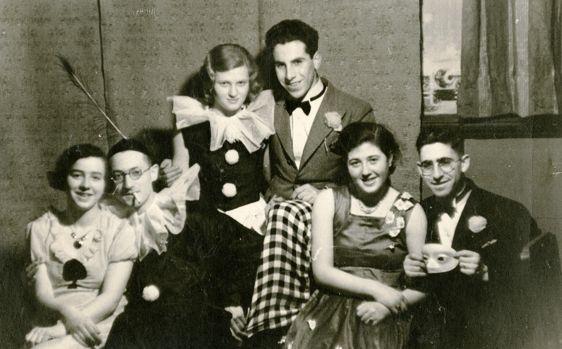 Three young Dutch Jewish couples celebrate Purim in prewar Holland.

Pictured are Ammy and Nico Herschel (left), Ammy's sister Bilha and her husband, Aaron Davidon (center), and unidentified friends.  Aaron Davidson perished during the war.