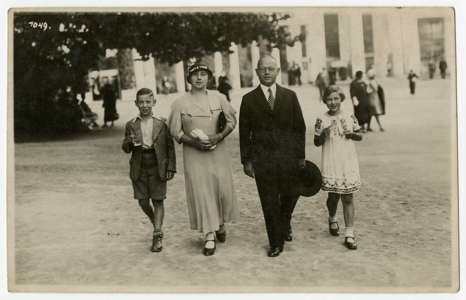 The Mueller family walks down a street of Marienbad while visiting the spa.

From left to right are Norbert, Laura, Sebald and Suse Mueller.