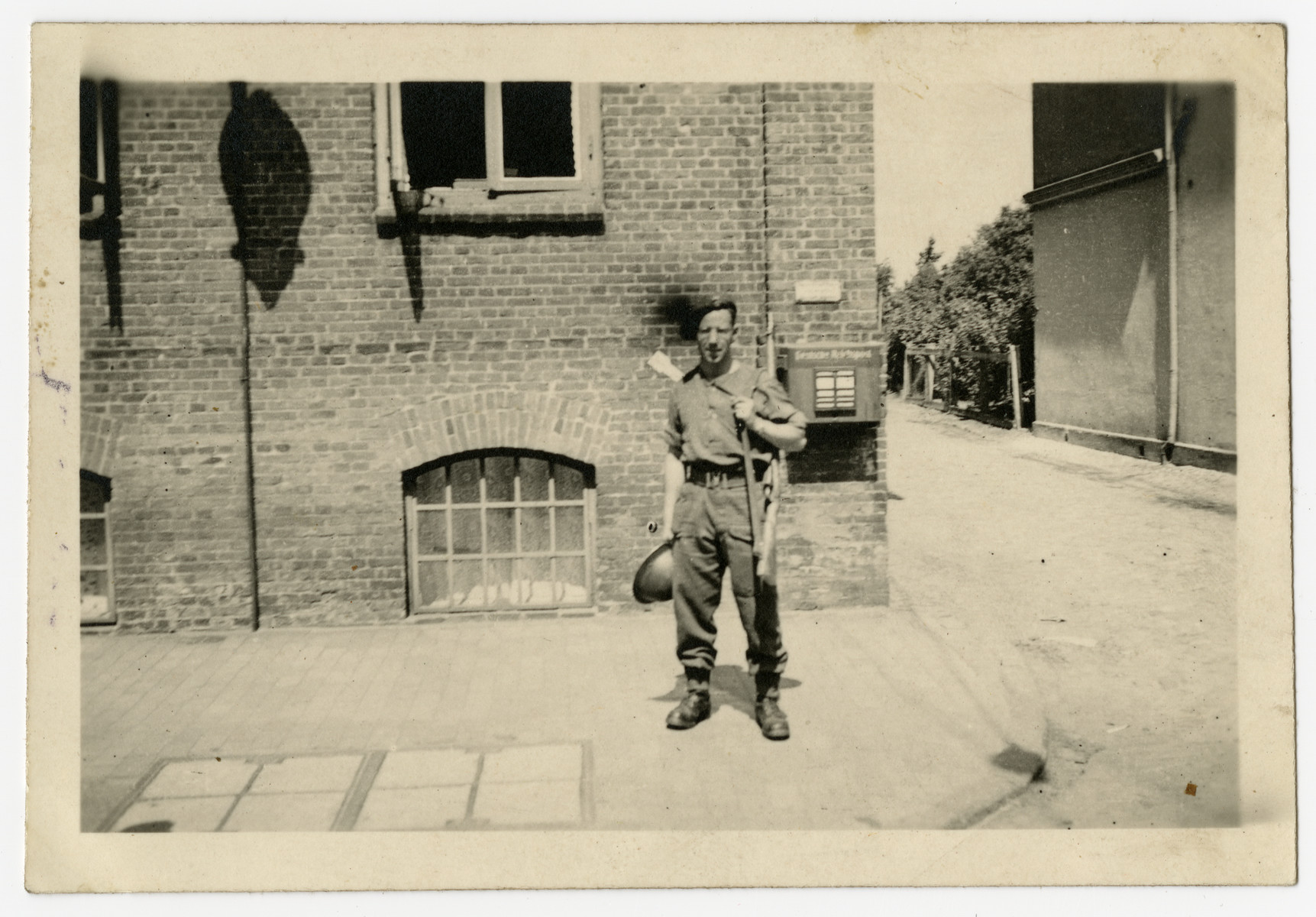 Norman Miller stands with his rifle and helmet while serving with the Royal Welsh Fusiliers.