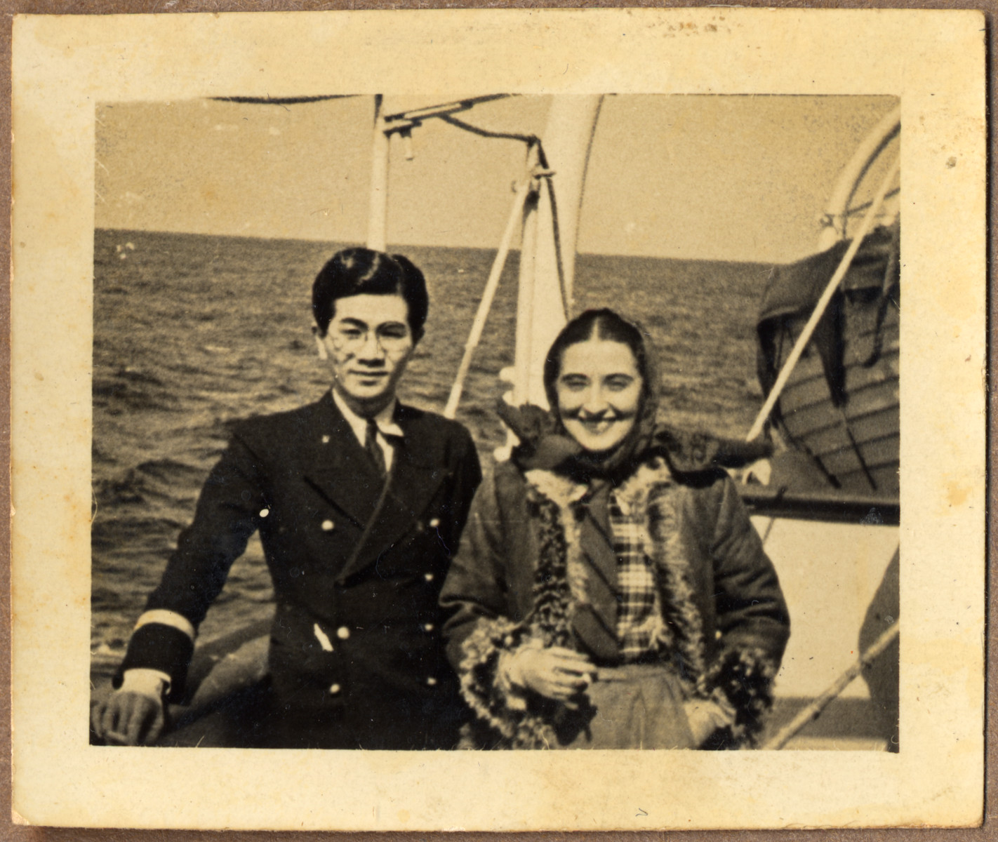 Tatsuo Osako's poses on board the Amakusa-maru with a female