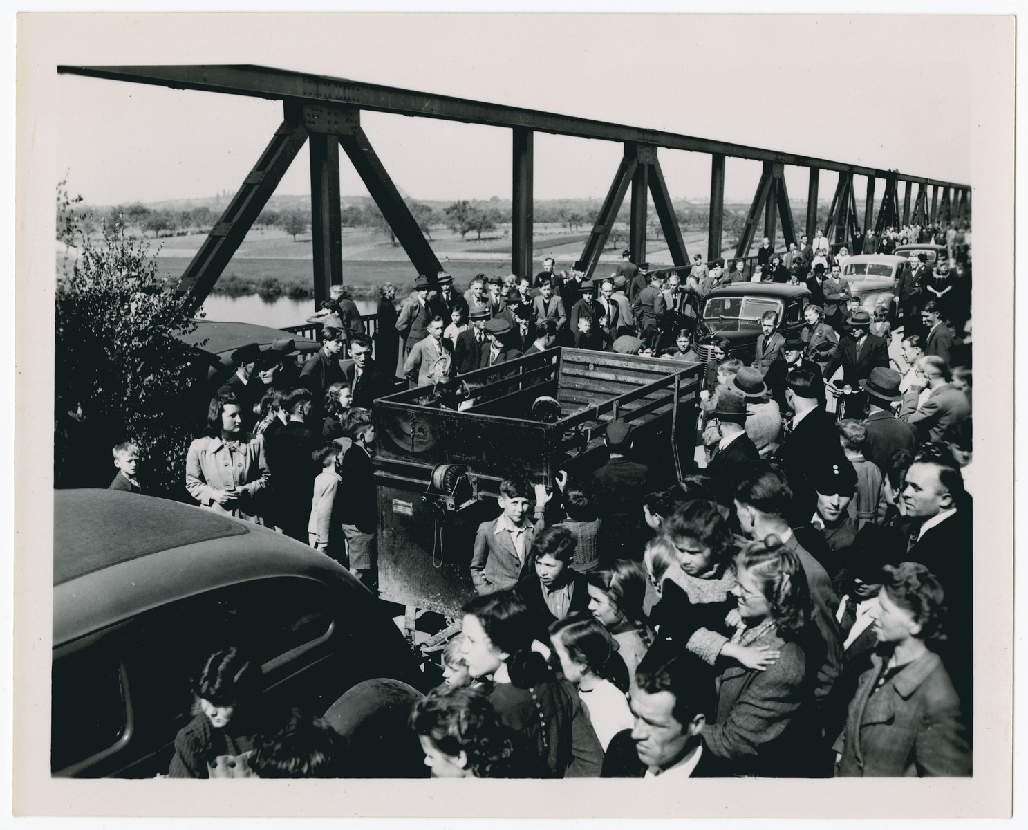 [Refugees stream across a bridge in postwar Germany.]  Caption not confirmed.
