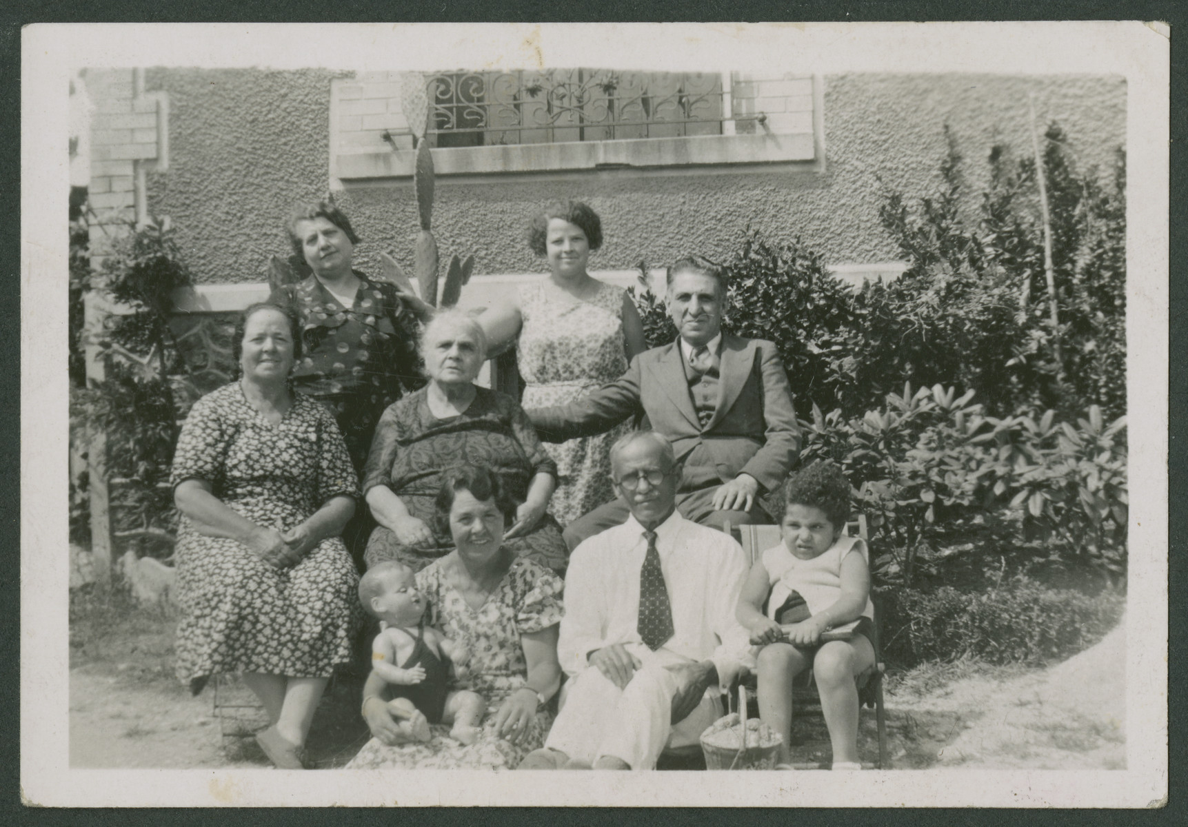 The Arditti family sits outside their home.

Jacques Arditti's grandmother (maden name Jaffe) is seated in the center.  His mother is standing on the left and his father is seated on the right.