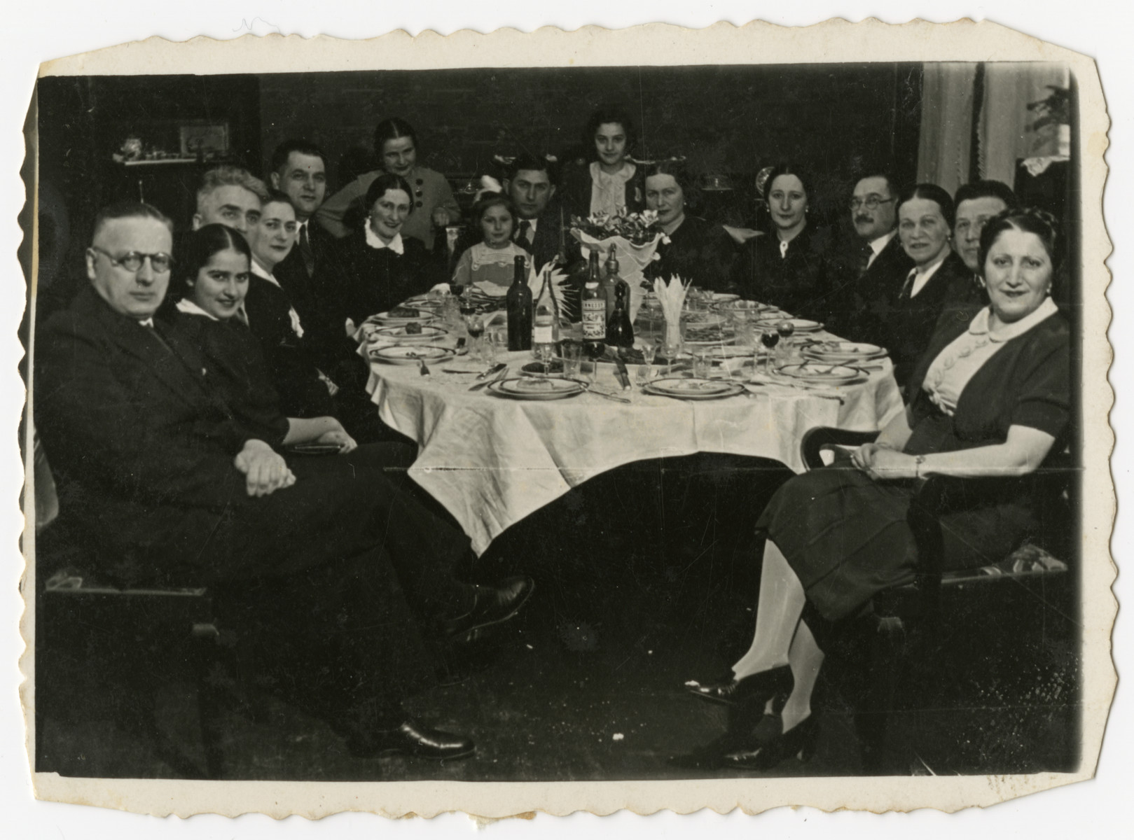 The Wajcblum and Jaglom families gather for a Passover seder in Brest.

Estusia Wajcblum is standing in the center, rear.  Seated at the head of the table is Moise Jaglom is holding his daughter Jeannette.  His wife Klara  is on the right with the pearl earrings.