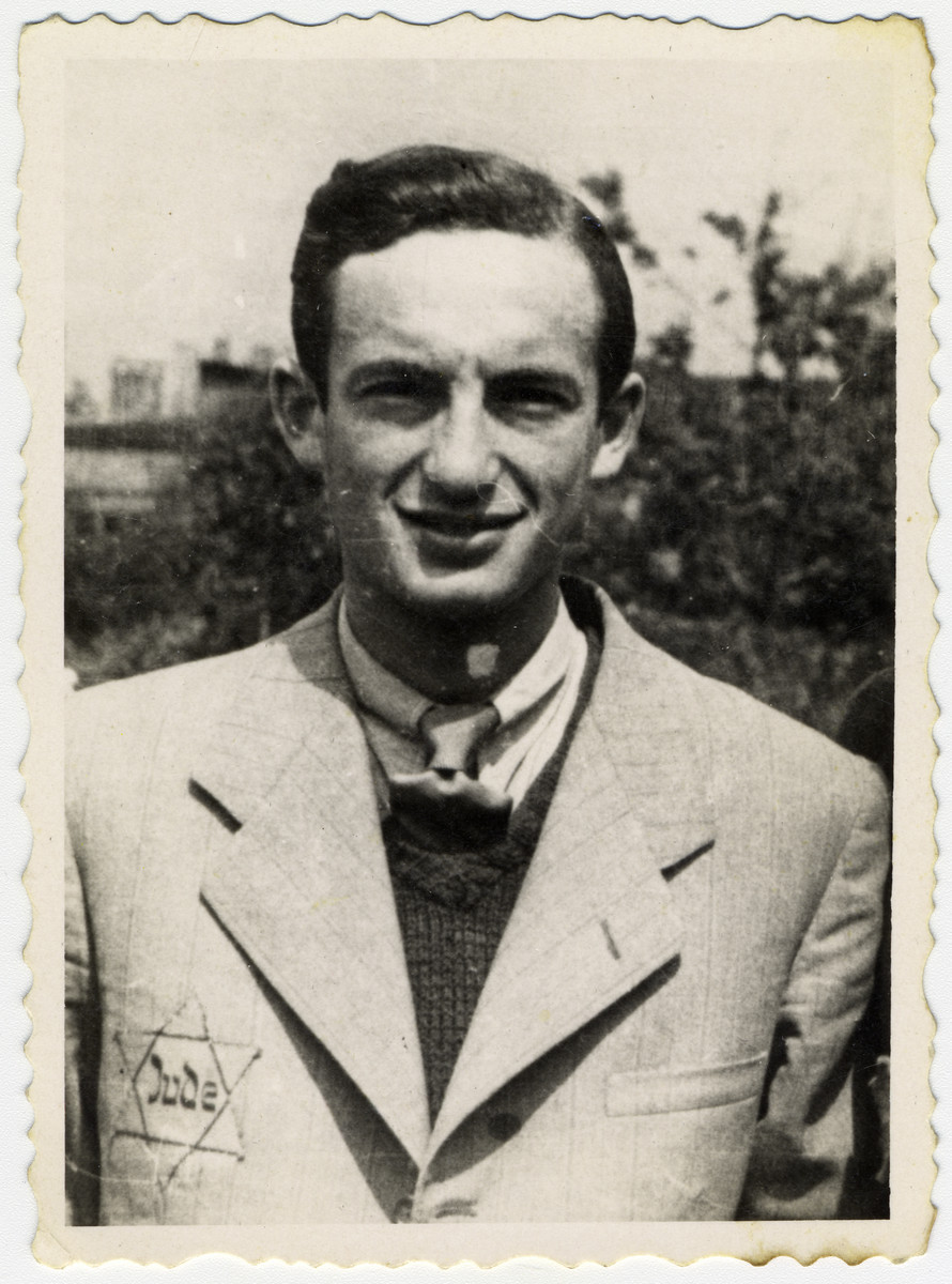Close-up portrait of a German Jew in the Lodz ghetto wearing a Star of David. 

Pictured is Maniek Kaplan.