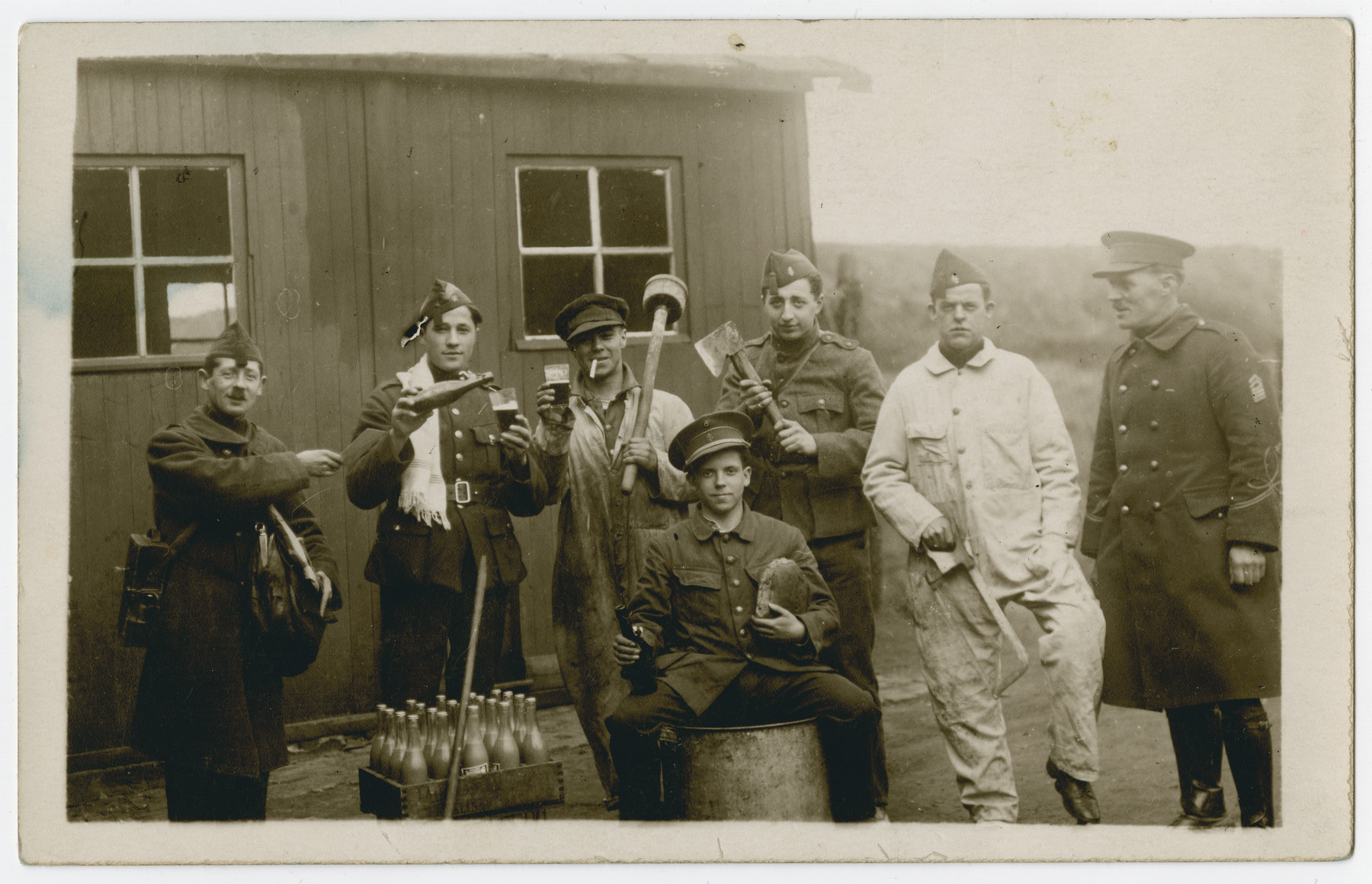 Belgian soldiers enjoy a case of beer.

Leopold Guttman is standing third from the right with an axe.

[Note: The photograph was with other Stalag 10C photos but from the activity it is likely that this photograph may be prewar.]