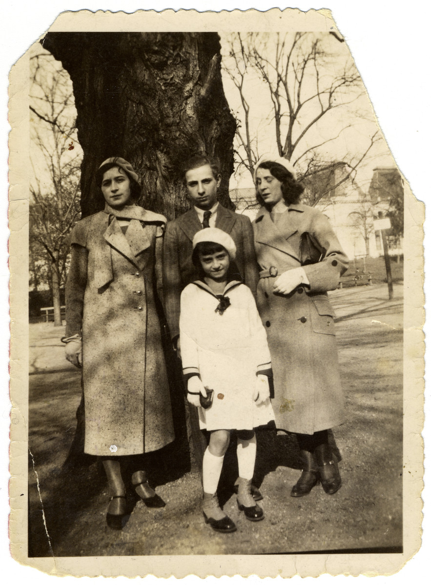 Four Hungarian siblings pose beneath a tree.

Pictured are the siblings of Katalin Biel -- Gizella, Jeno, Ibolya and Teri Herland.  All four were deported to Kamenets Podolsk where they perished.