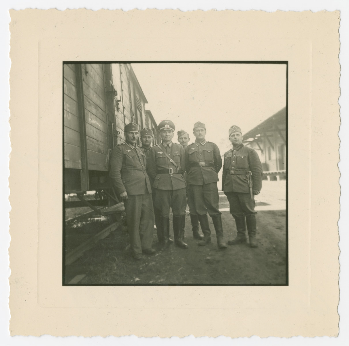 German soldiers stand  next to a train in Oswiecim less than two weeks after the invasion of Poland.