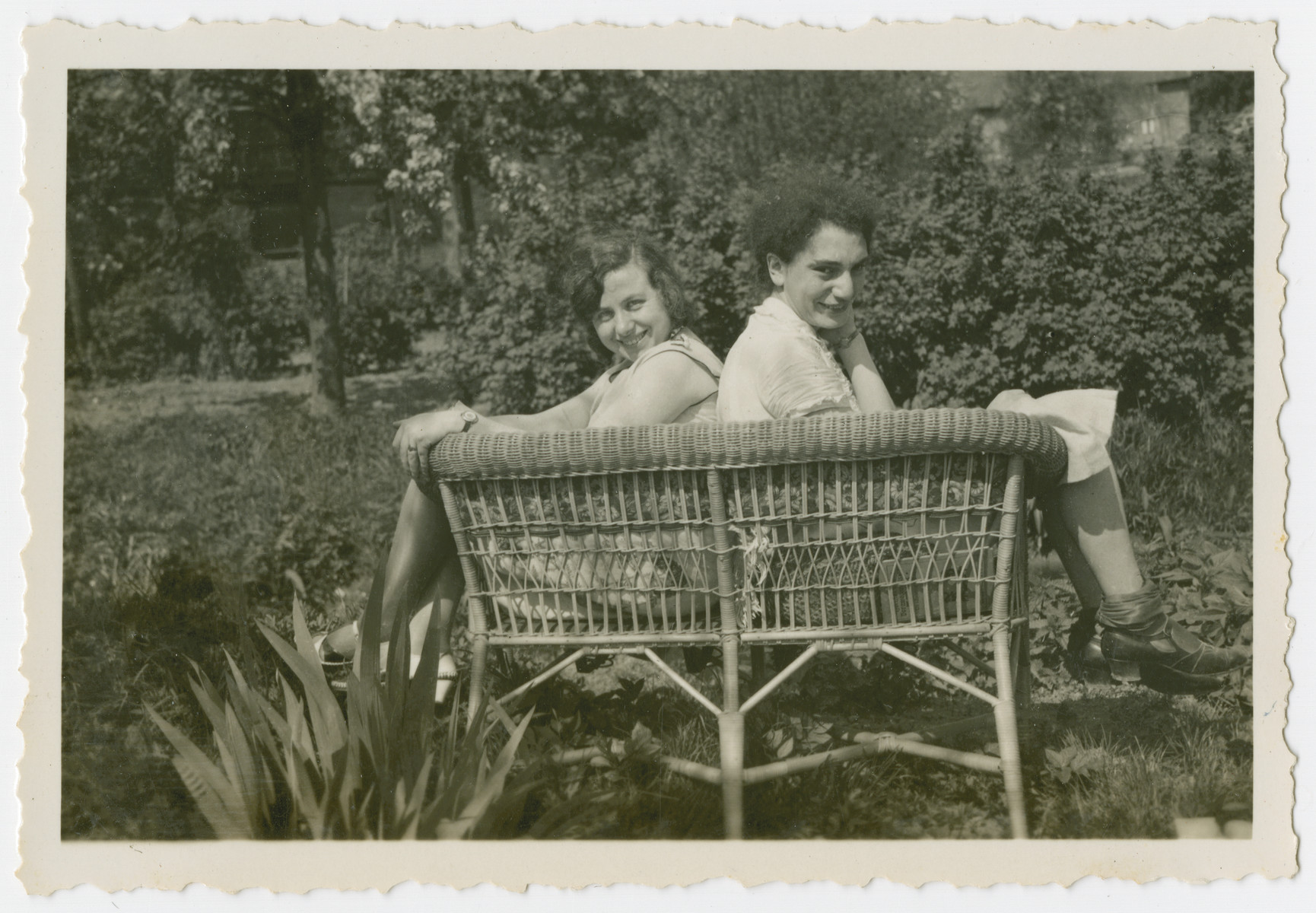Two young women sunbathe in a garden.

Edith Kleeblatt is pictured on the left.