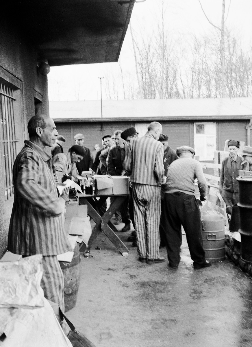 Recently liberated survivors of Buchenwald in the care of the U.S. Army's 45th Evacuation Hospital wait for the distribution of rations.