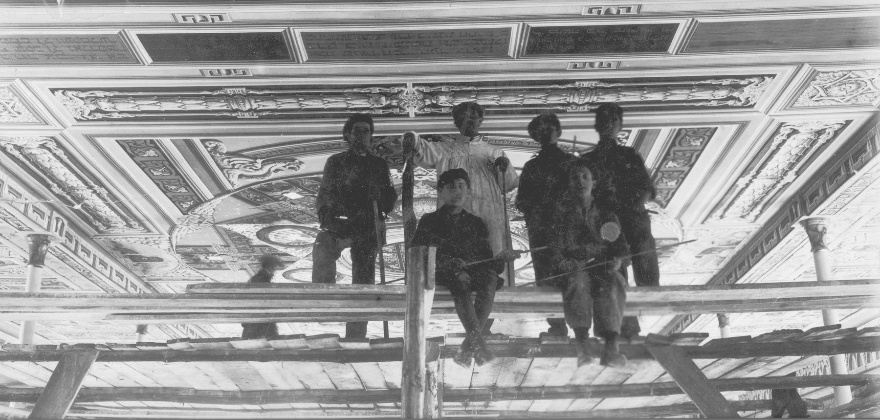 Perec Willenberg (pictured center, wearing white) and his staff paint the old synagogue ceiling mural in Czestochowa.