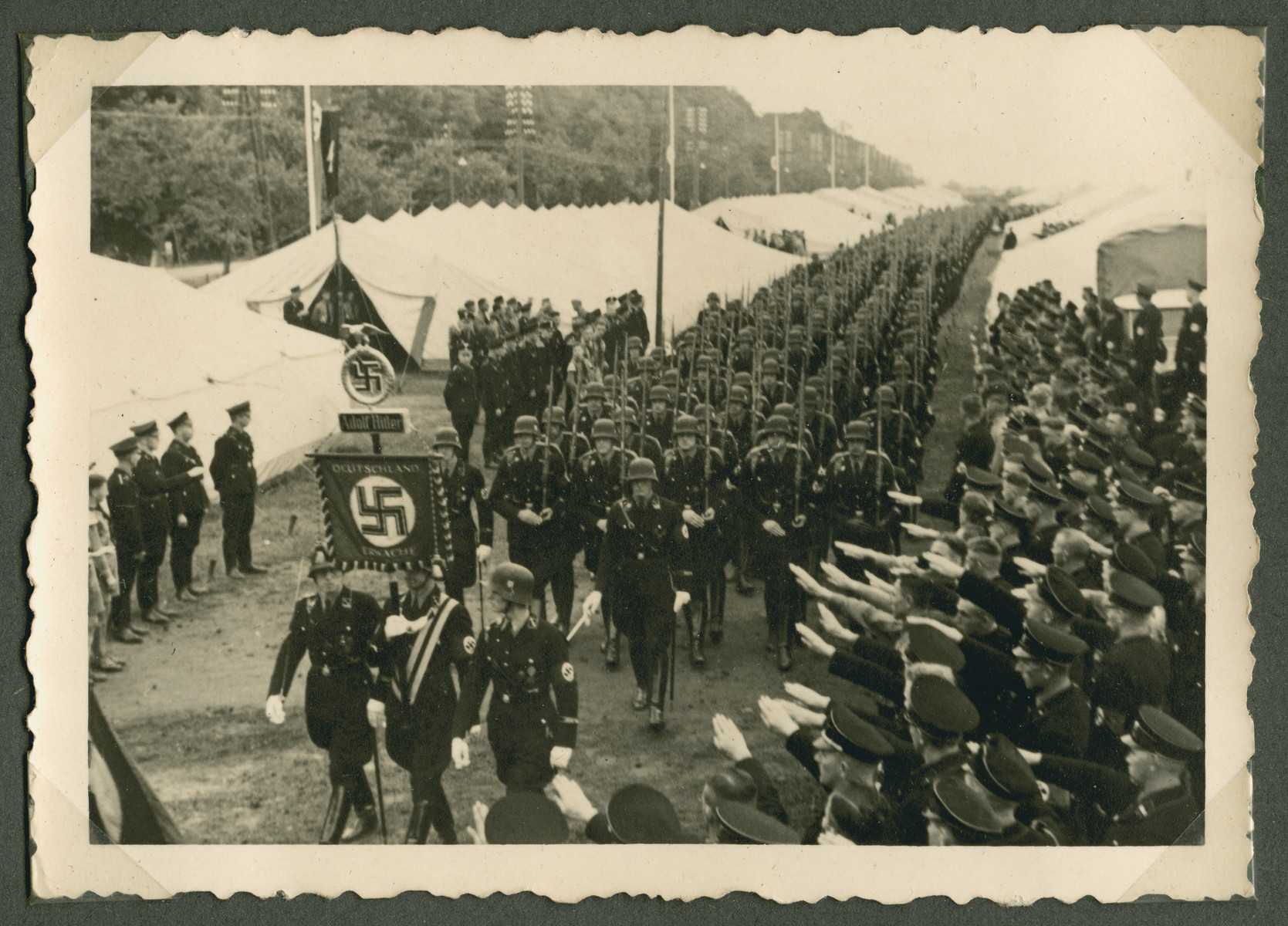 SS troops march past a slauting crowd during the Reichsparteitag in Weimar.