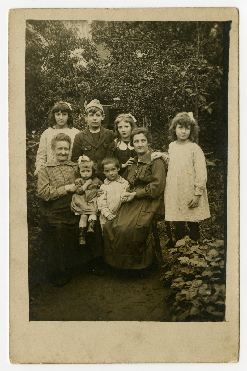 A French family poses in a garden in prewar Paris.

Among those pictured is Marte (later Weber).