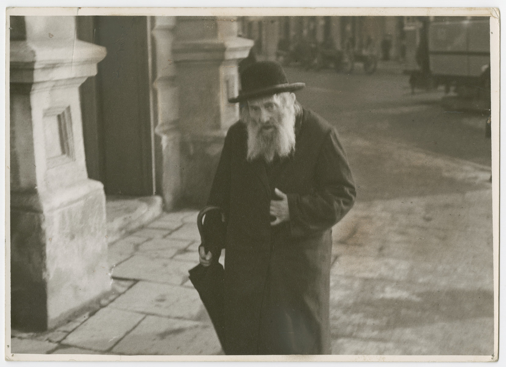 An elderly Jewish man  walks down Nalewki Street in Warsaw.

Photograph is used on page 108 of Robert Gessner's "Some of My Best Friends are Jews."