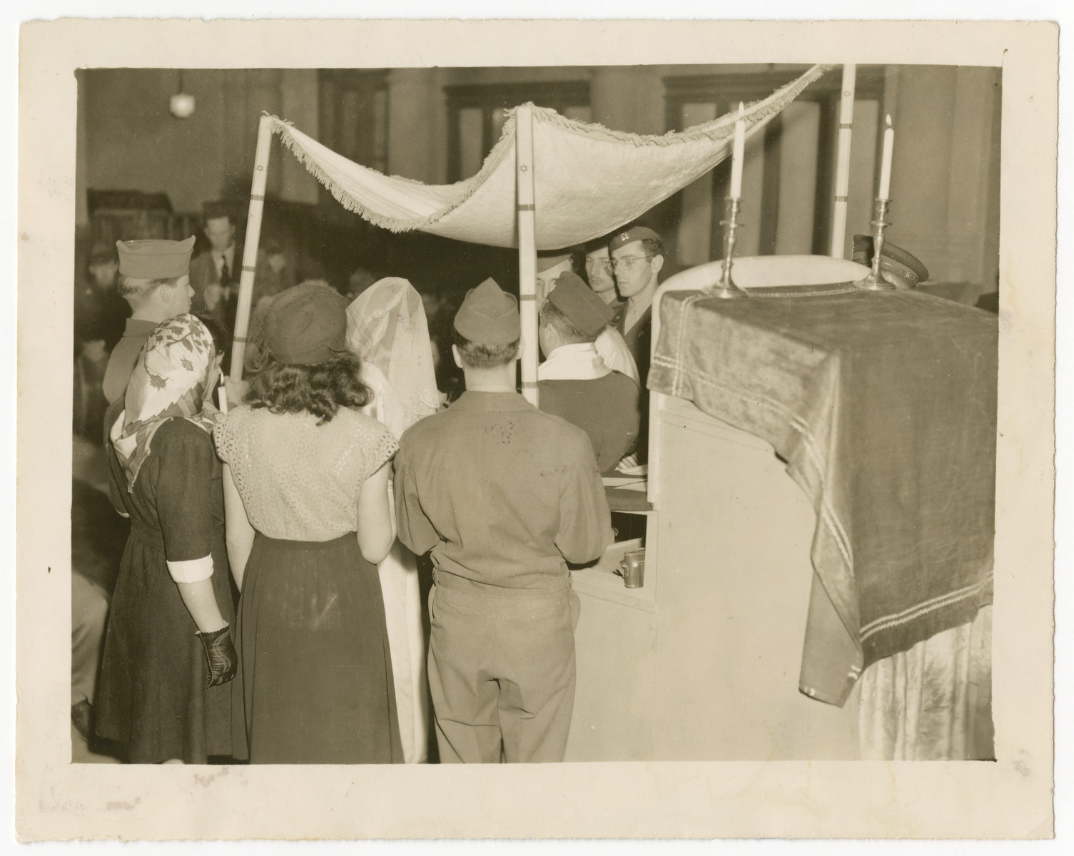 Rabbi William Dalin officiates at a wedding in the Zeilsheim displaced person camp.

Escorting the couple are American aid workers Lorna and Gil Adelman.