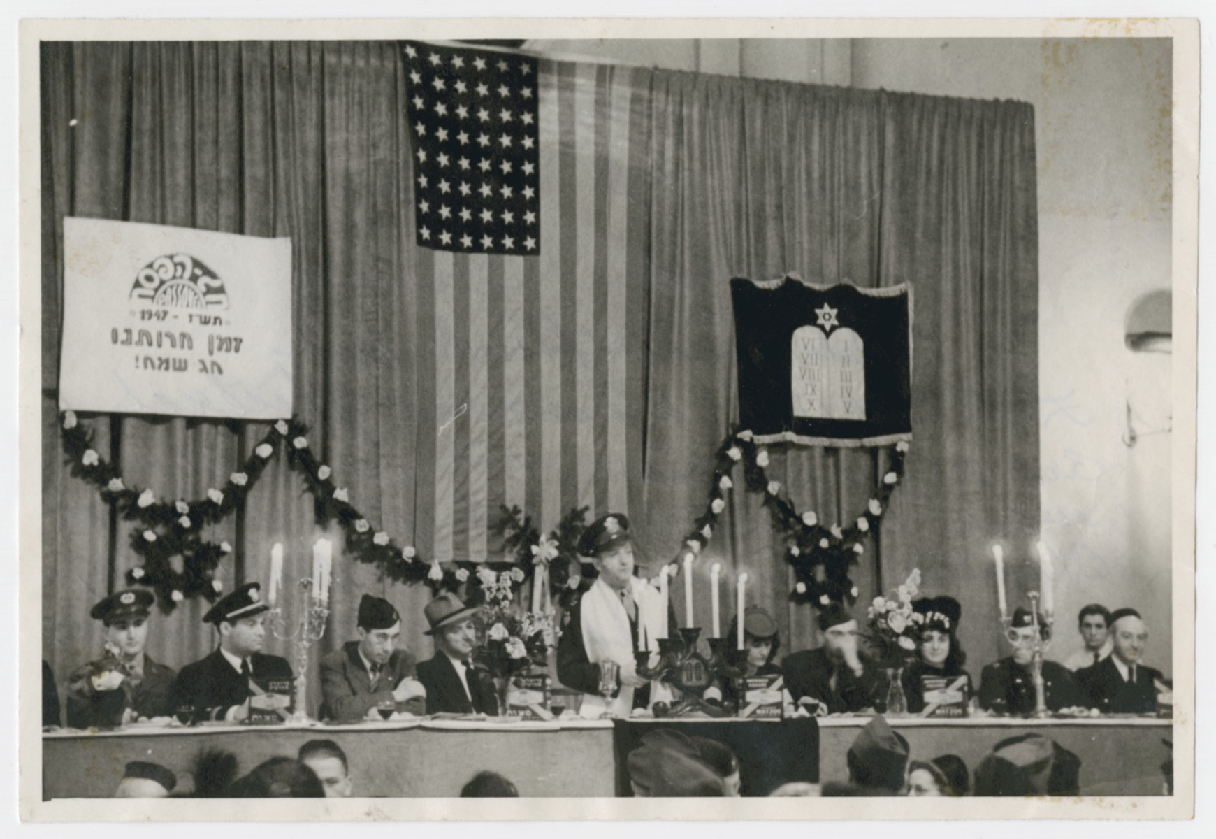 Rabbi William Dalin conducts Passover services in the newly rededicated synagogue in Wiesbaden.

Left to right: two American officers, 3rd person unknown, Dr. Frum who was a DP and president of the Congregation Chapter, Rabbi William Dalin, , Bella Dalin. unknown, Lorna Adelman, Gil Adelman, unknown.