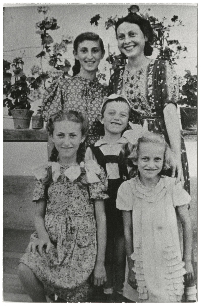 Group portrait of the Fogel and Klarman families.  

Pictured in the front row are Iren Fogel, Zoltan Klarman, and Edith Fogel.  Back row: Serena Fogel and Bella Klarman.