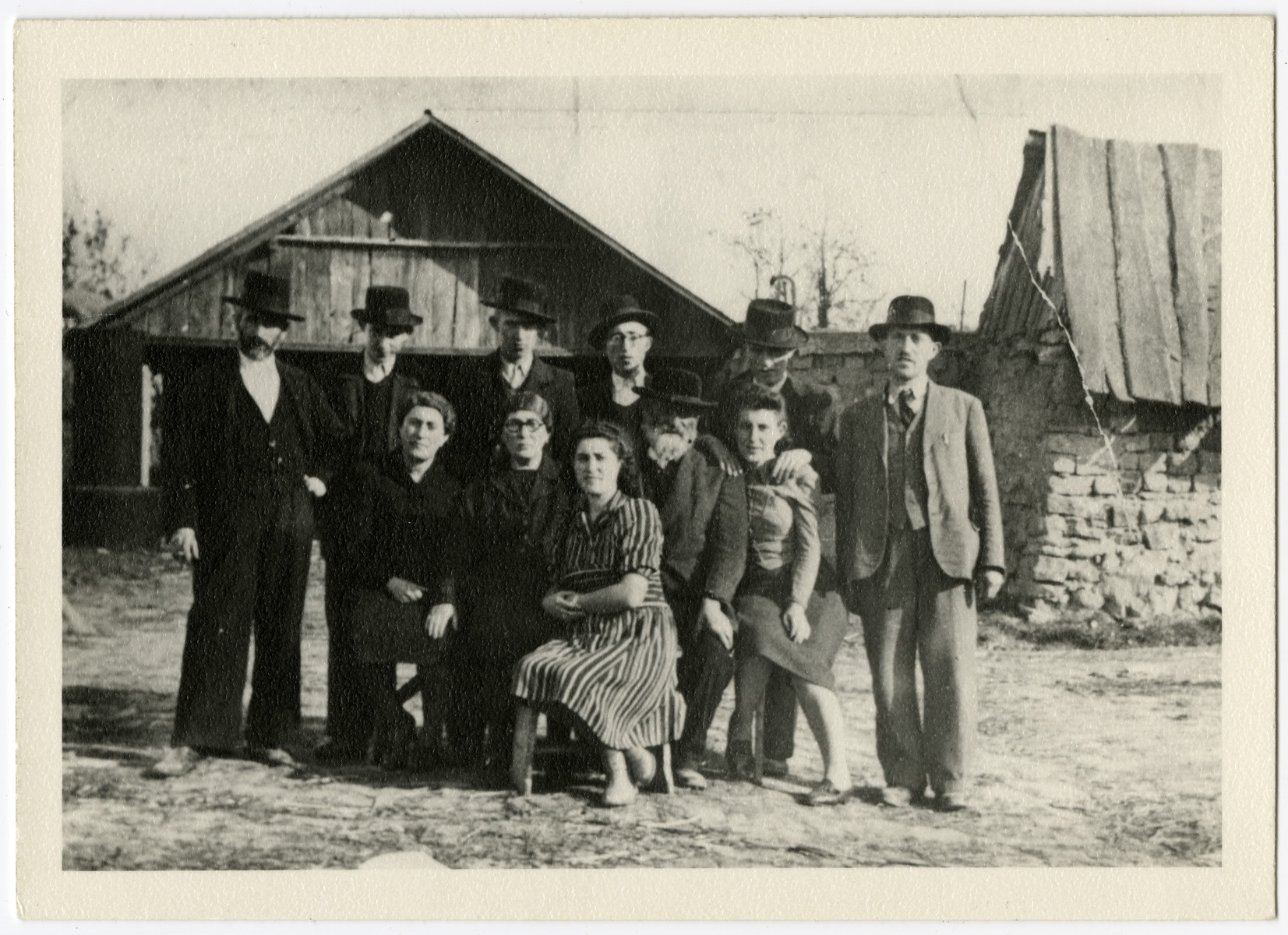 Group portrait of the extended Fogel and Mermelstein family.

From left to right are (back row): Meyer Fogel (perished), Shia Mermelstein (survived), Shulem Mermelstein (survived), Haim Leib Mermelstein (perished), Asher Mermelstein, (survived), and Boruch Mermelstein (perished).
 
Front row:  Malvina Mermelstein Heimfeld (survived), Tzivia Mermelstein (grandmother of the donor, perished), Rose Mermelstein (survived), Hersh Mermelstein (grandfather of the donor, perished), Pearl (Piri) Mermelstein (perished).