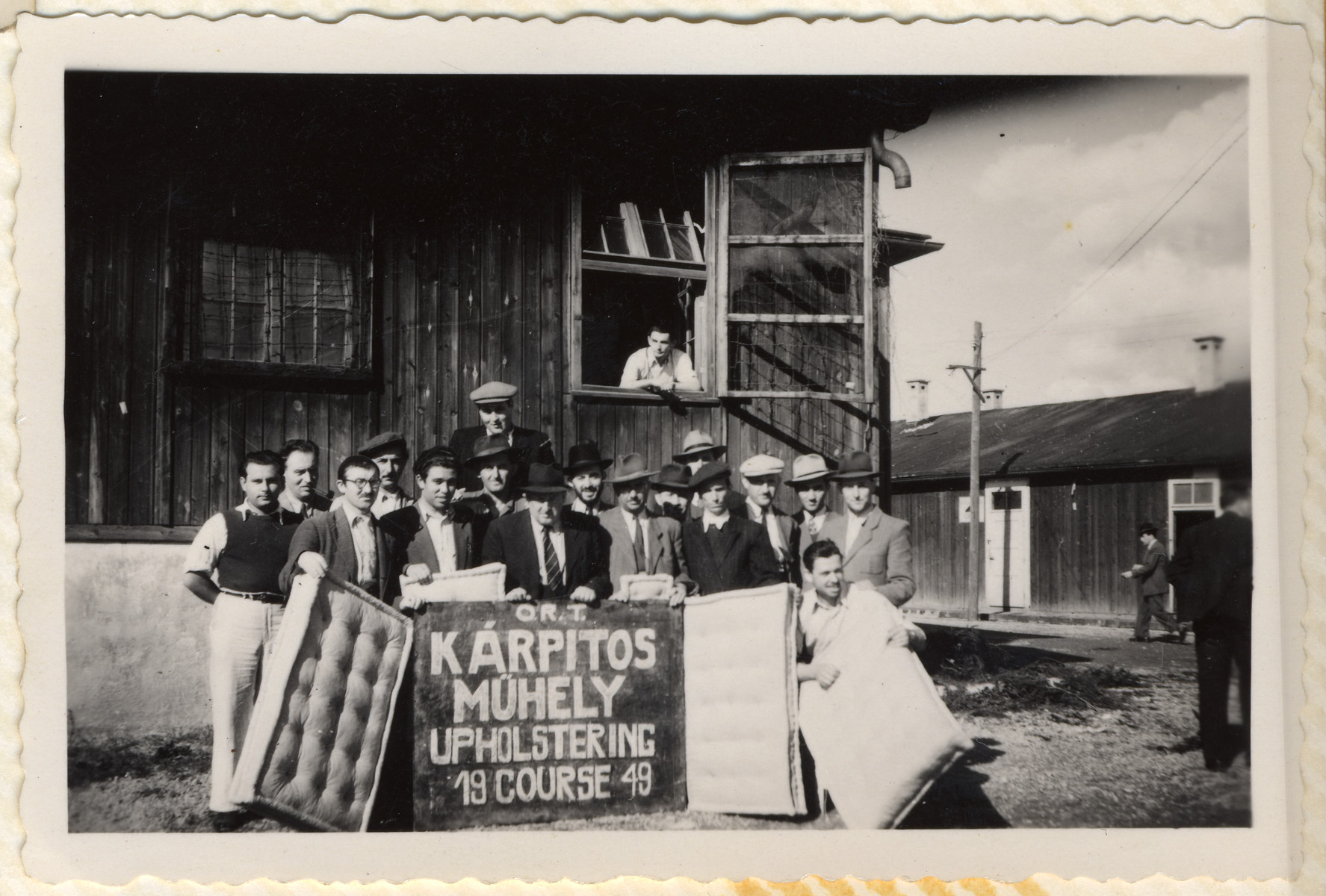 A group of Jewish men pose with the mattresses they made in the ORT upholstering course in the Hallein displaced persons' camp.