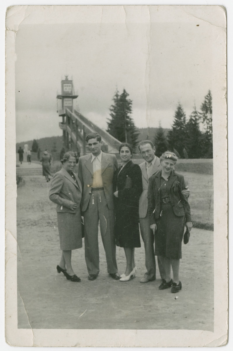 Group portrait of young adults standing in a park.

Among those pictured are Szymon Bur and his fiancee Genia Josefsberg.