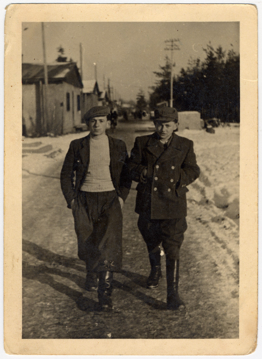 Two teenagers walk through a snowy street in the Pocking displaced persons' camp.

Zvi Hirsh Brill is on the right.
