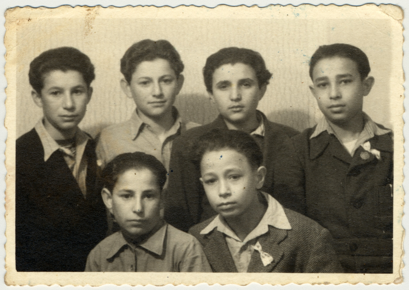 Studio portrait of a group of teenagers in the Rosenheim displaced persons' camp.

Pictured in the back row from left to right are Motle Goldfinger, Tzvi Brill, unknown, Aaron Miller.  Seated in front of Aaron Miller is his brother.
