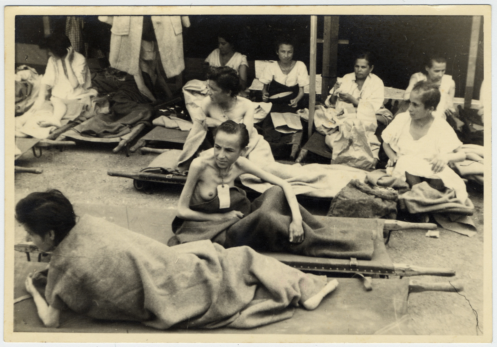 Female Bergen-Belsen survivors rest on stretchers.