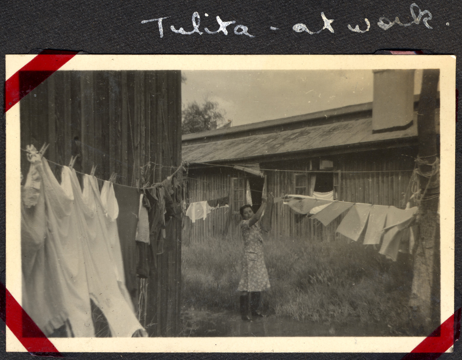 A woman hangs laundry up to dry in the Ash Colony in Shanghai.

The original caption reads, "Tulita - at work."