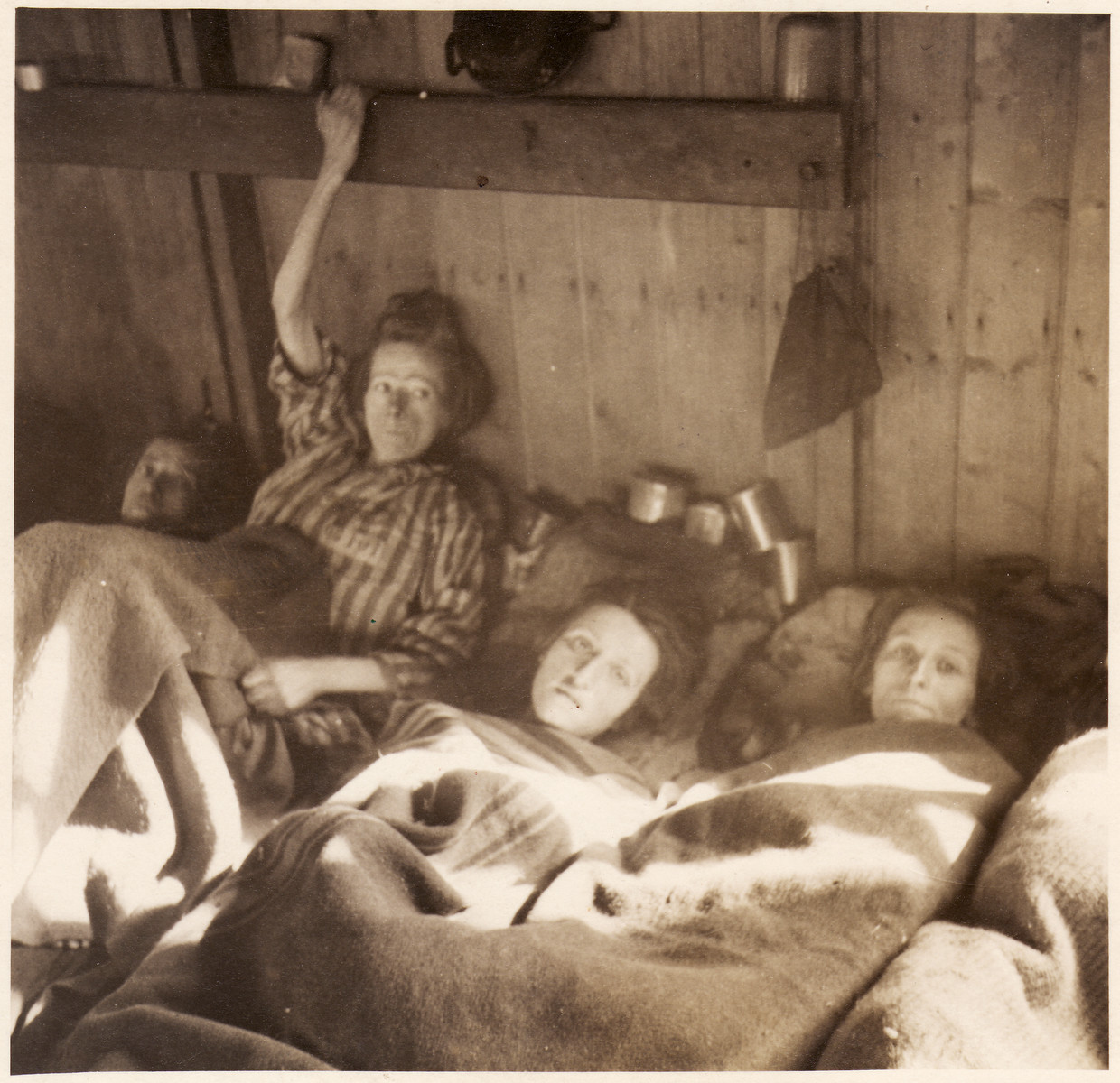 Female survivors lie in bunks inside the barracks of the Bergen-Belsen concentration camp.

Among those pictured (center) is Berthe Berkowitz (later Lautman).