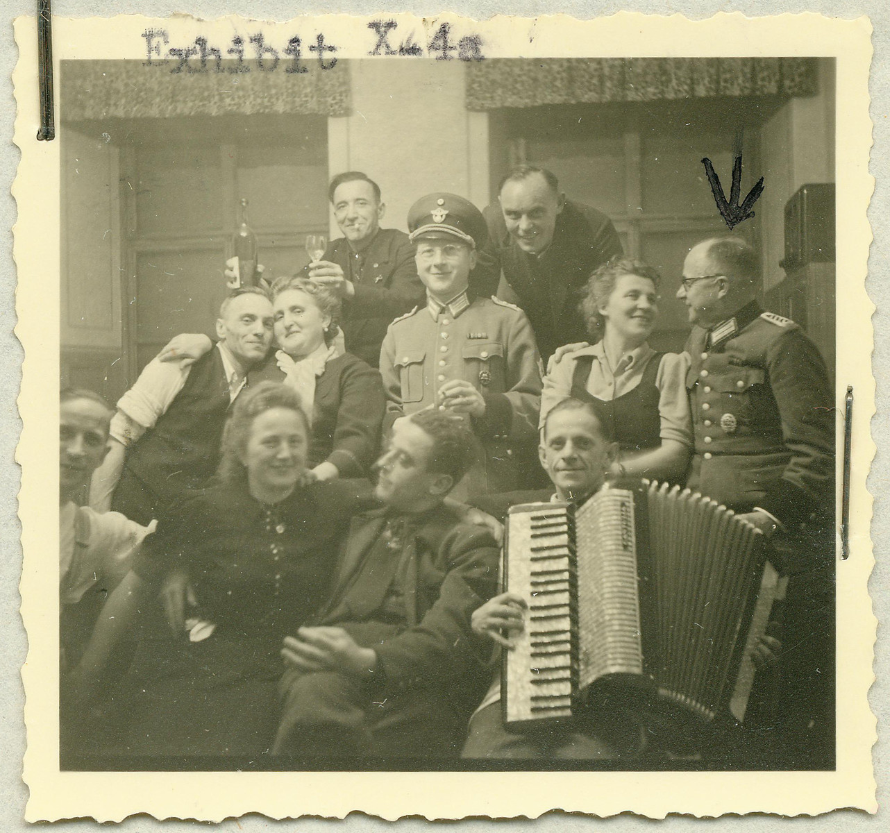 Group portrait of the staff of the Hartheim euthanasia facility relaxing with an accordian.