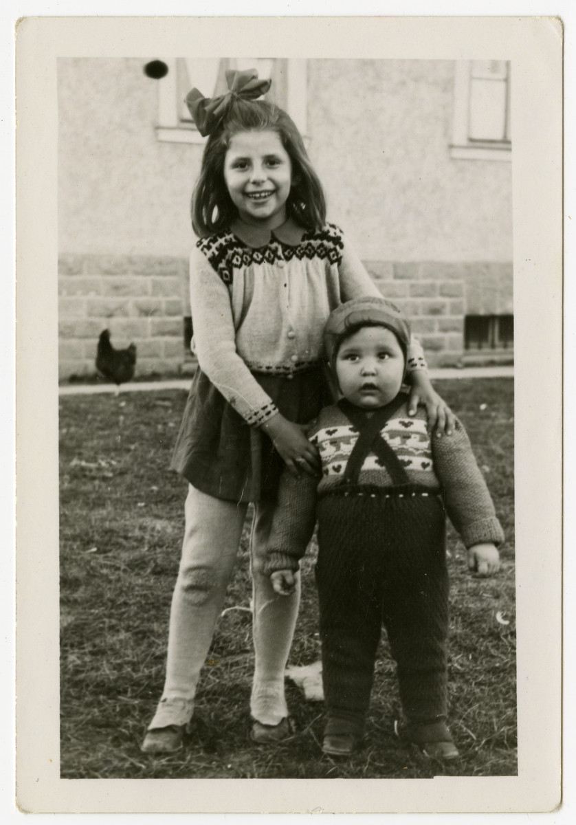 Moshe Sadik poses with an older girl in the Braunau displaced persons camp.