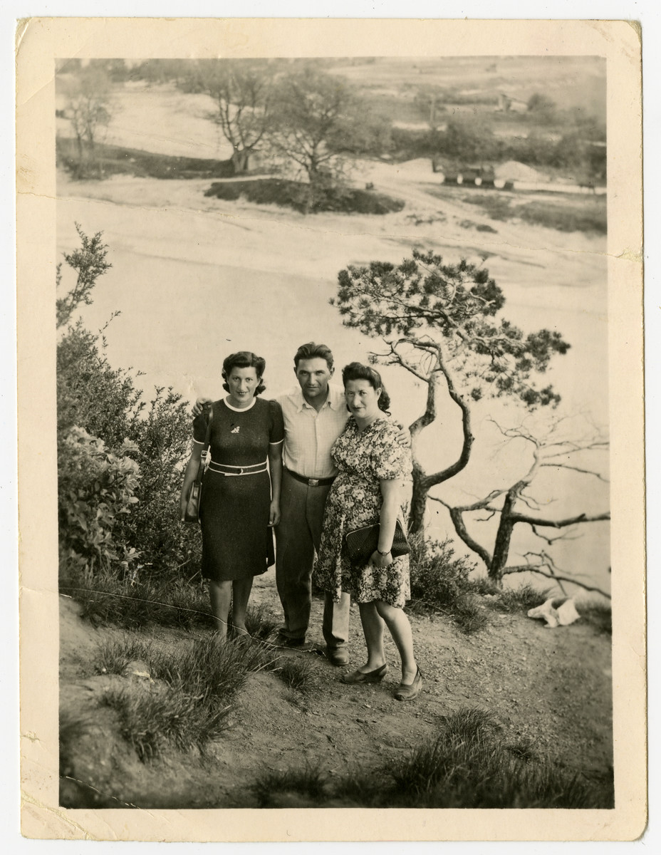 Three Jewish DPs stand on banks of either the Steyr or the Enns river.

Nachman and Miriam Sadik are on the right, and Miriam's cousin Czarna Kulas Zimmer is on the left.