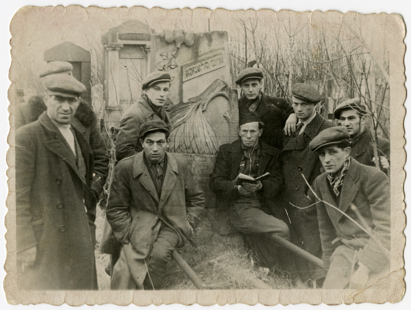 Jewish survivors pray in the desecrated Jewish cemetery near Lublin.

Leon Korn is standing in the back second to the right.