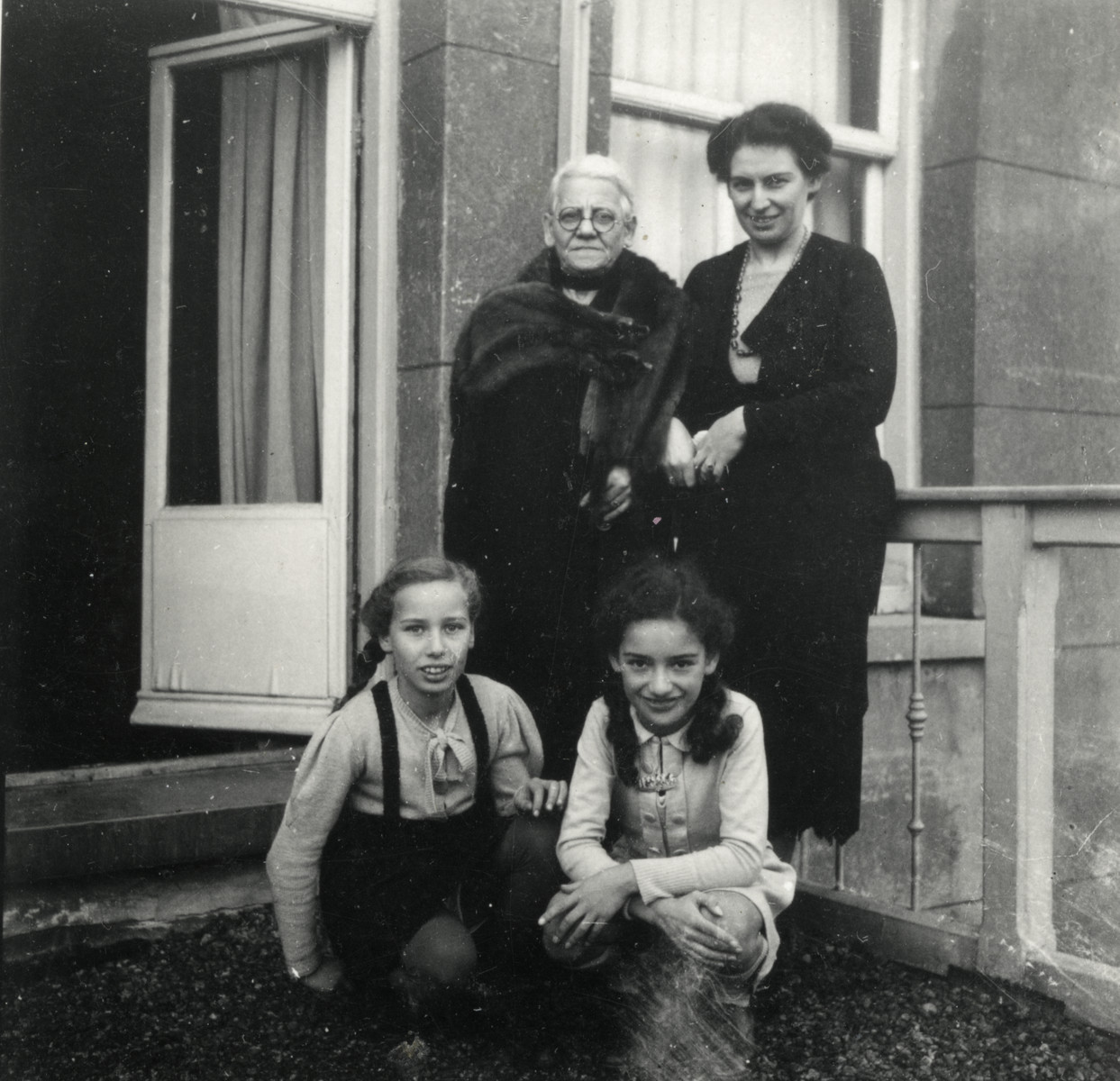 Prewar photograph of the women of the van Collem family standing outside their apartment.

Pictured are Marta and Ilse van Collem, their mother Lotte and grandmother.