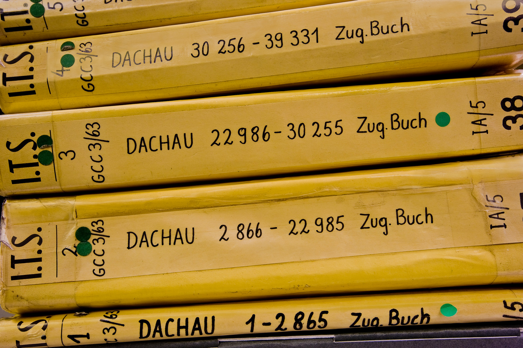 View of five I.T.S. Dachau records books stacked horizontally.