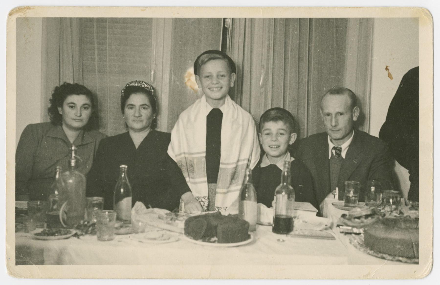 Yitzchak Weinberg celebrate his bar mitzvah with his relatives.

From left to right are Rivke Kupfer Weinberg, Ruche Wullinger (a greataunt), Yitzchak Weinberg, Alter Weinberg and Hircsh Mayer Weinberg. Yitzchak, Alter and Hirsch Mayer all escaped Poland through the Kalb rescue mission.