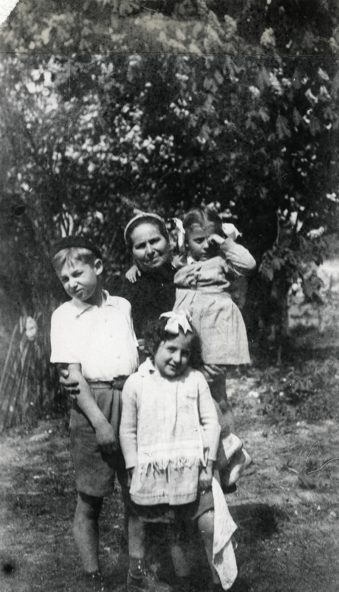 Mrs. Josepovitz poses with three of the children in her charge in the Foublaines children's home.

Ewa Margules is in her harms and Jacob (her adopted brother) is by her side. The original inscription reads: For my dear parents Jacob".