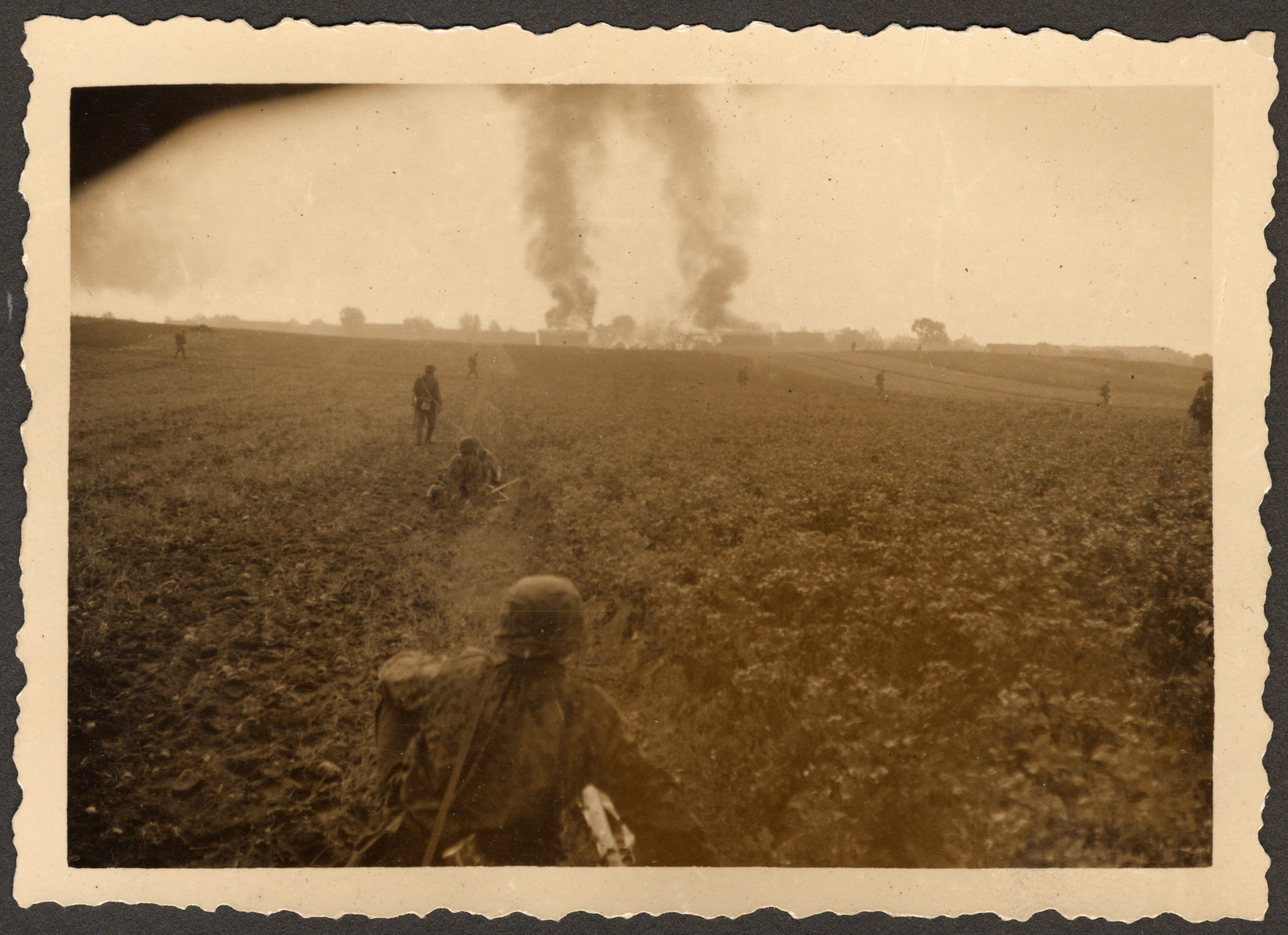 German soldiers during the Battle of Mlawa, as part of the invasion of Poland.

Original German caption read: "Action with *, * (burning village) in the Battle with Mlawa."