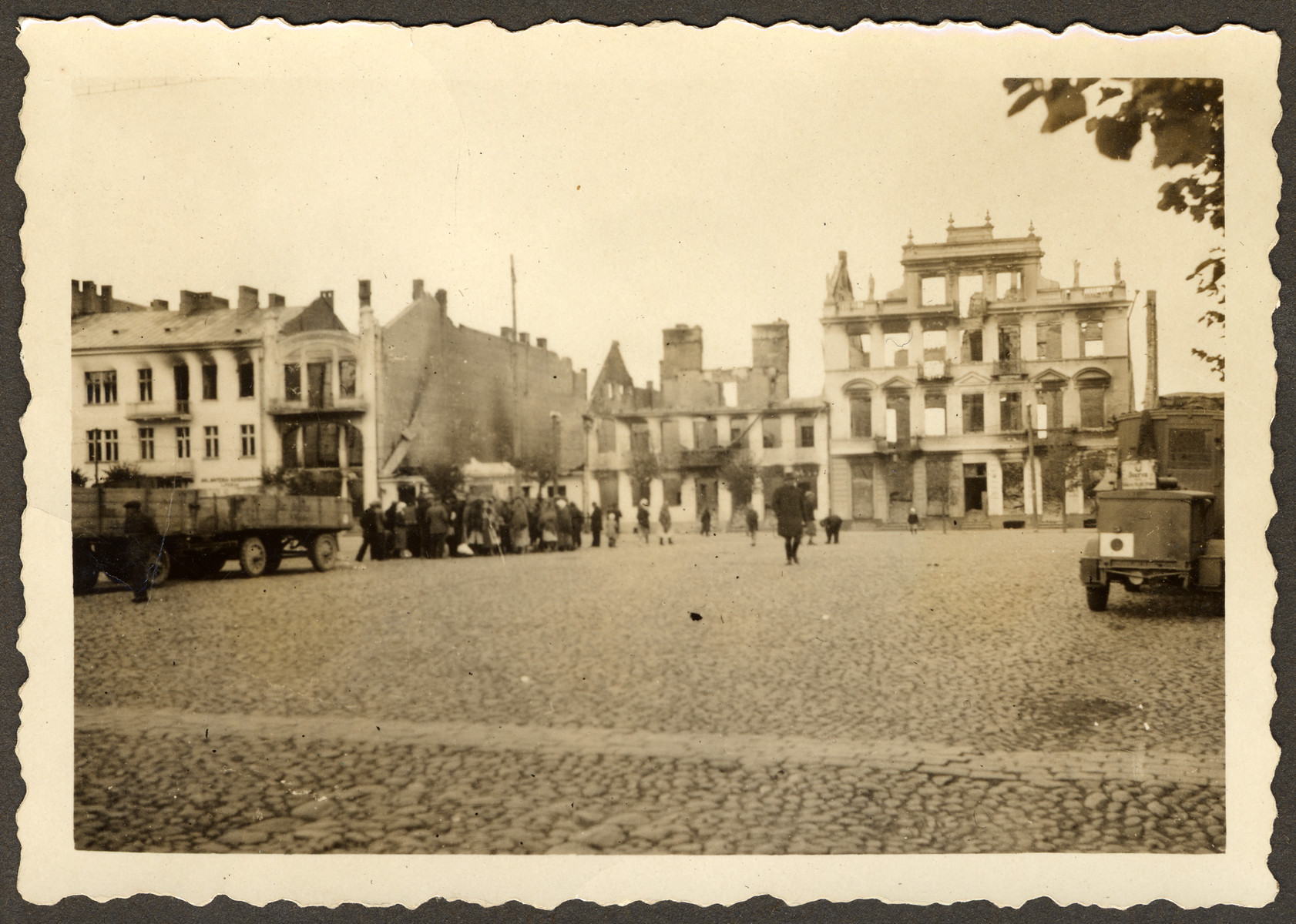 The ruins of the city square in Mlawa, near Warsaw, Poland. [There is a possible round-up going on in the center, near the large truck on the left hand side of the photo.]

Original German caption reads: "The city square of Mlawa."