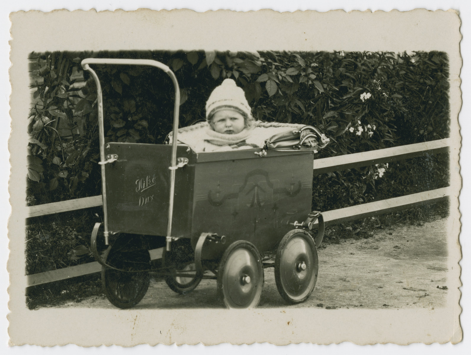 Close-up picture of a young child in a baby carriage in prewar Butrimonys.

Part of a collection of photographs depicting Jews from Butrimonys where some 750 Jews were rounded up and murdered by the Einsatzgruppen and Lithuanian collaborators after the invasion of the USSR.