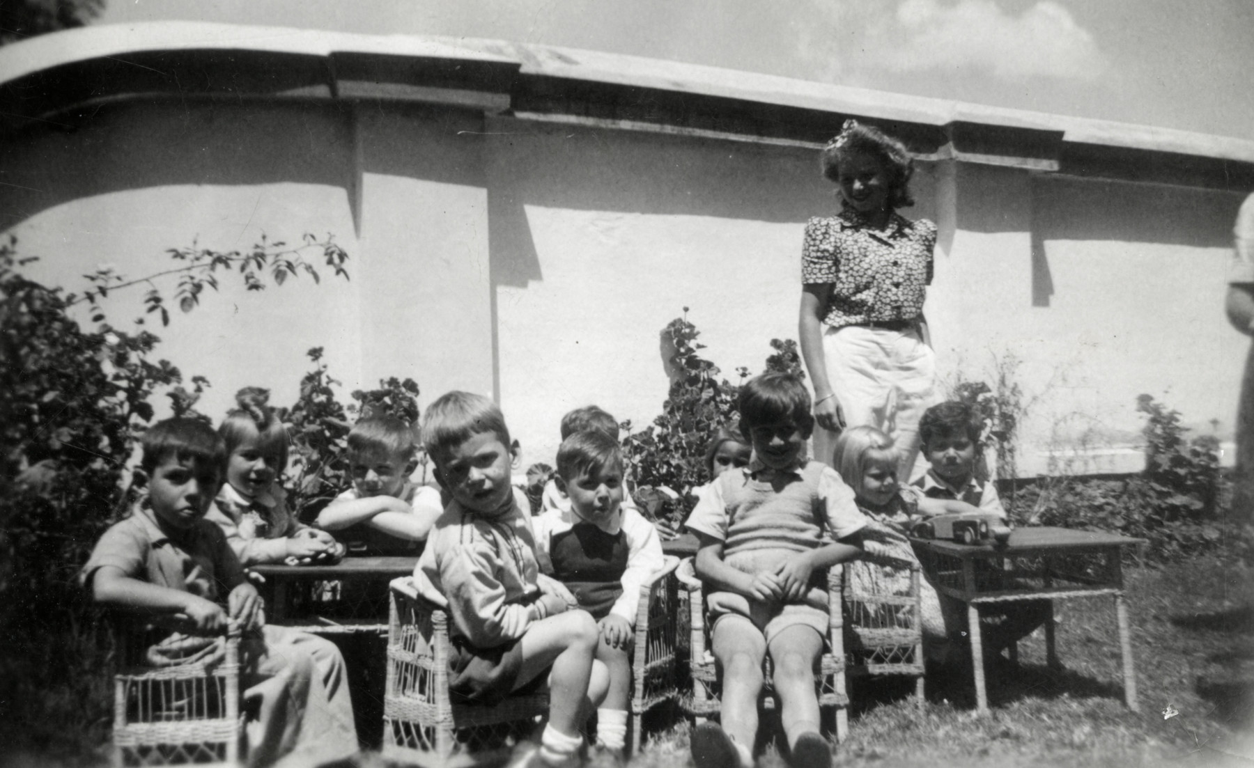 Erika Loebl stands behind the young children in her kindergarten in Quito, Ecuador.