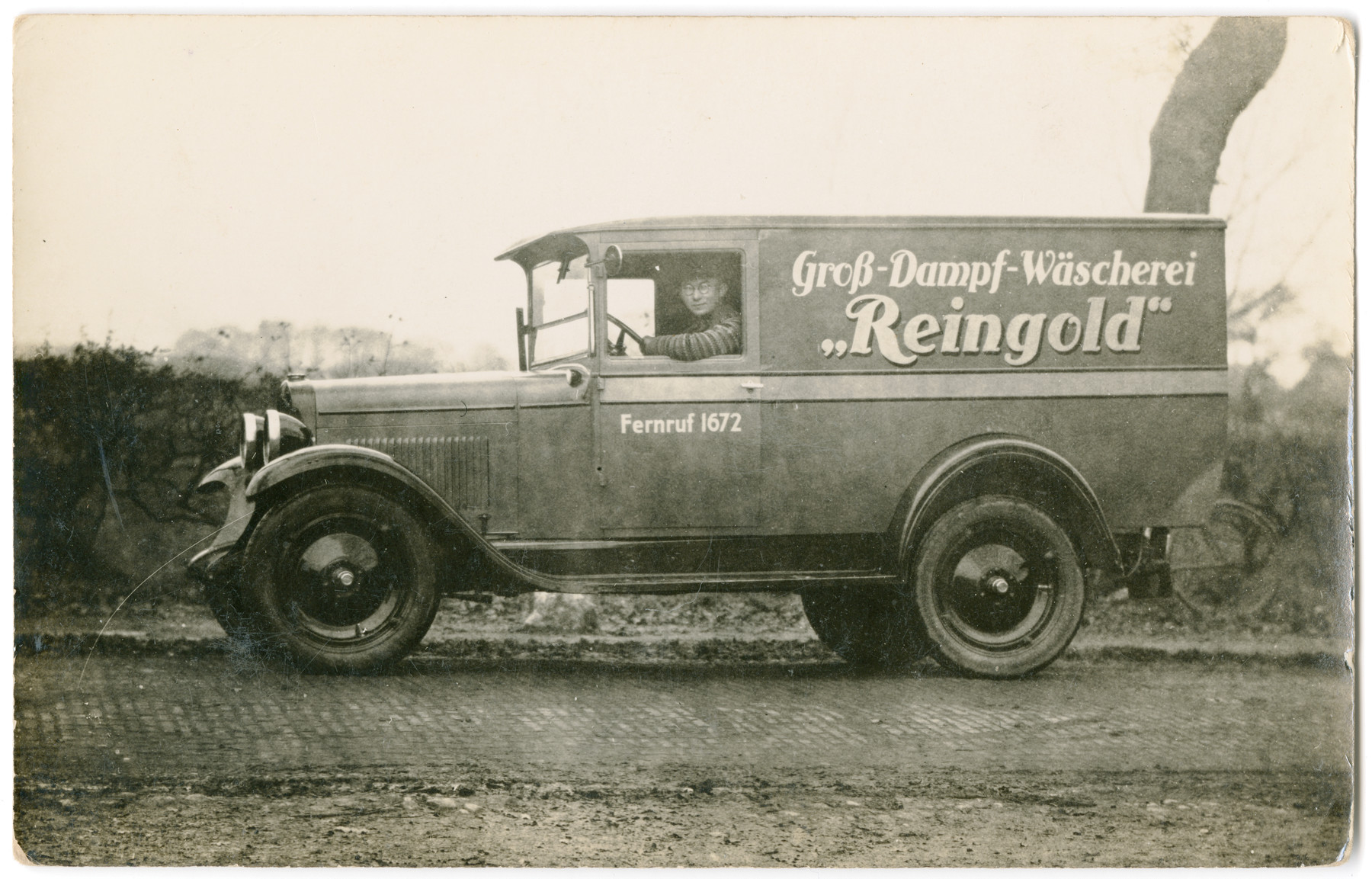 A member of the de-Beer family drives the truck of the family's laundry, "Reingold."