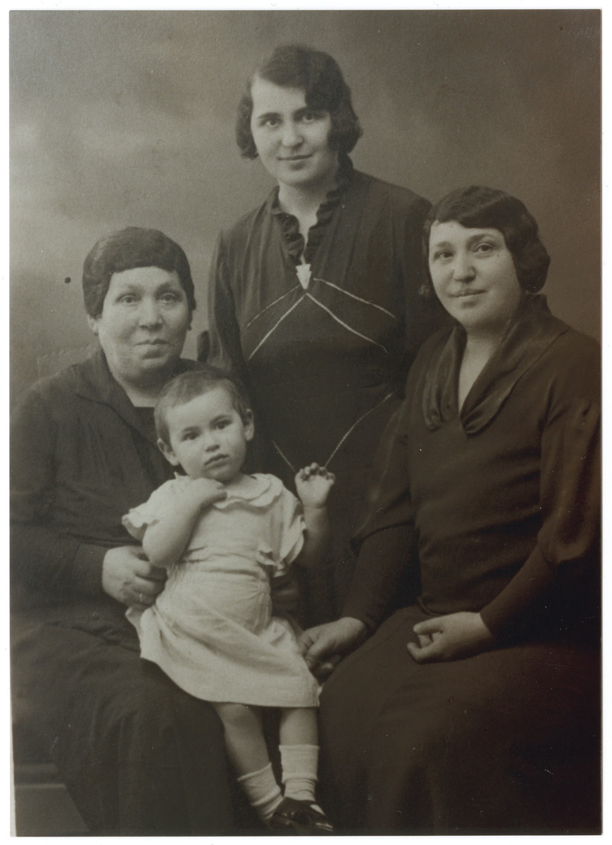 Studio portrait of four generations of the women of the Ksias family.

Pictured are great-grandmother Leah, grandmother Sara Ksias, mother Dora Ksias Teitelbaum, and Bertha Teitelbaum, age 2.