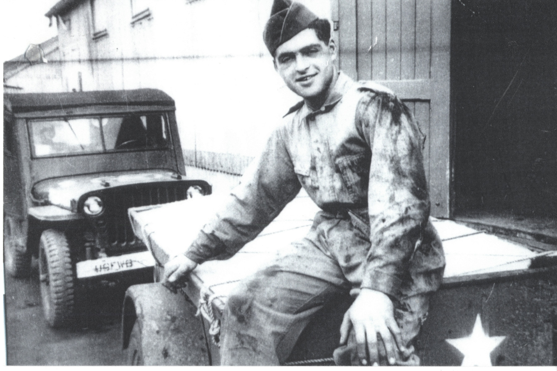 David Marcus seated on a military vehicle.