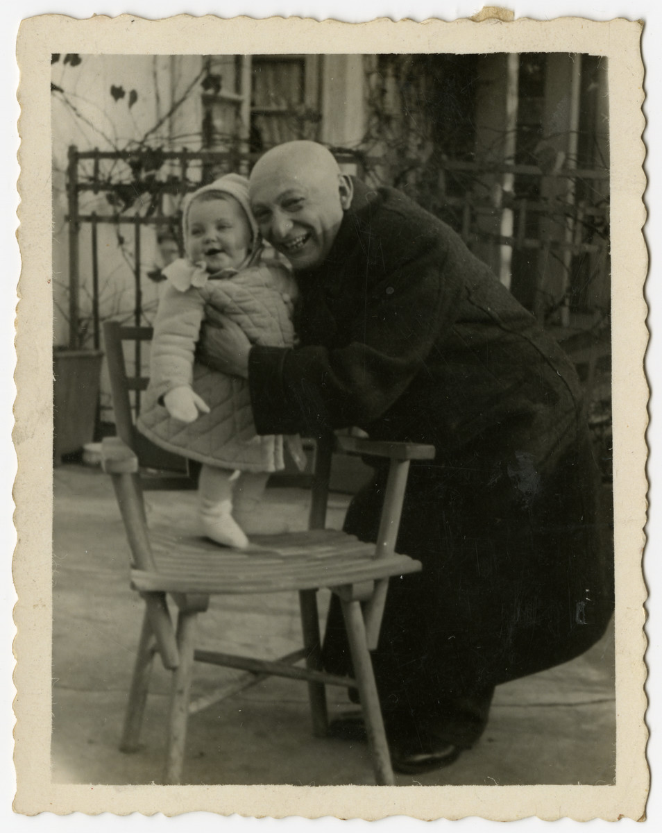 Benjamin Szymin hugs his baby granddaughter Helen.