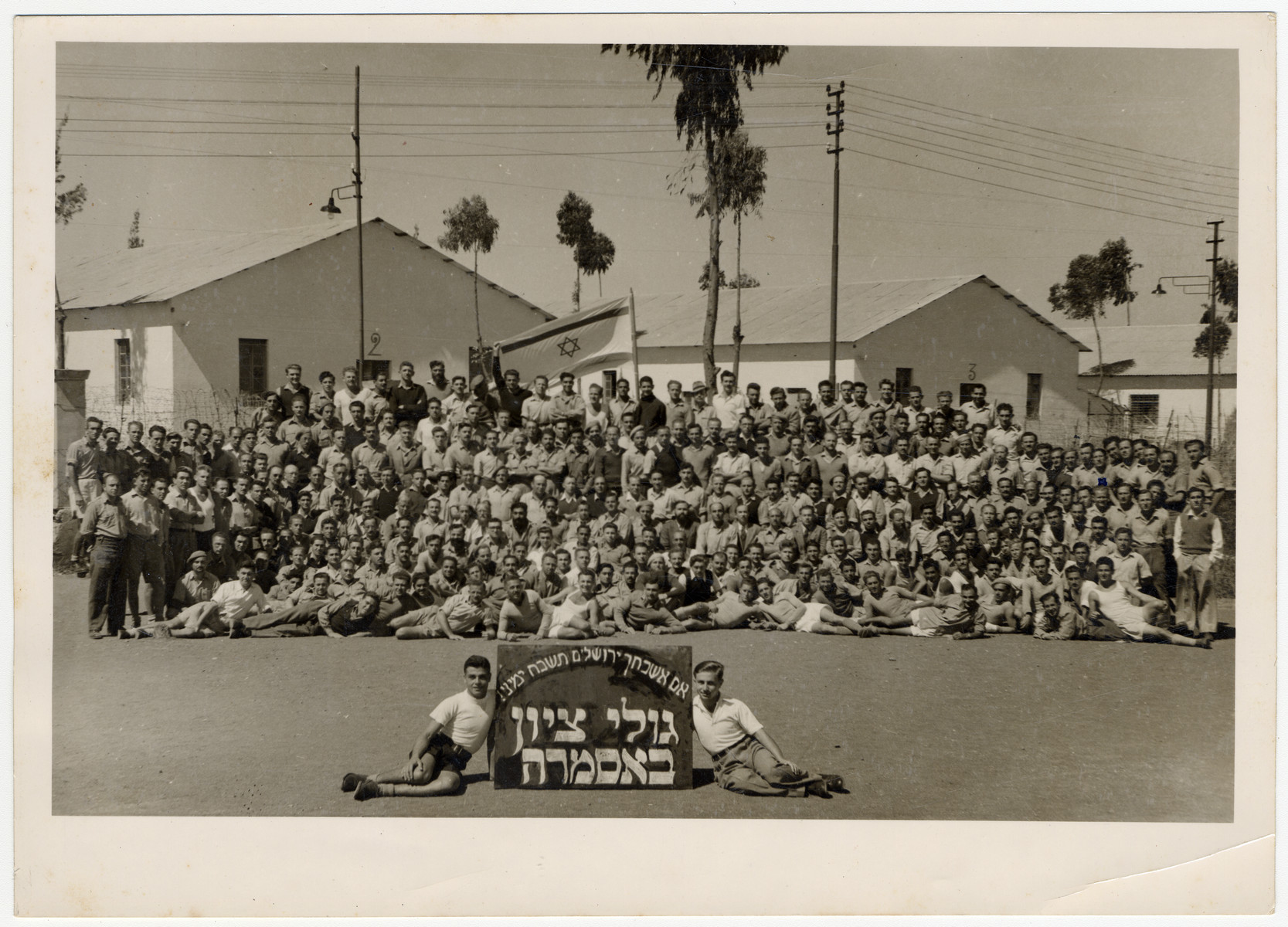 Group portrait of Zionist youth who were deported from Palestine and interned by the British in Asmara.  Most of them were members of either the Irgun or Lehi

The sign reads "If I forget thee O Jeruslaem, may my right arm be forgotten.  Zionist exiles in Asmara."